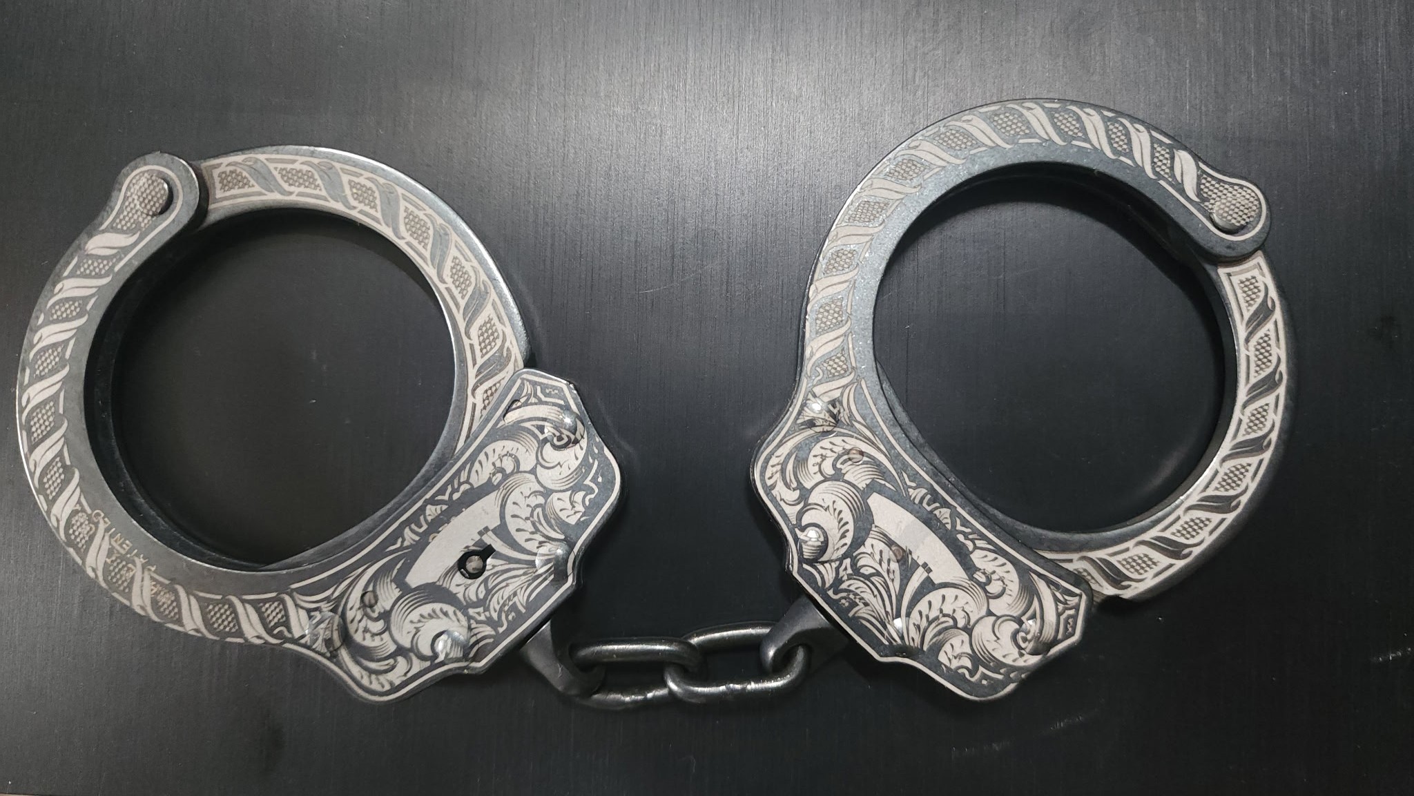 Custom engraved handcuffs with intricate scroll pattern