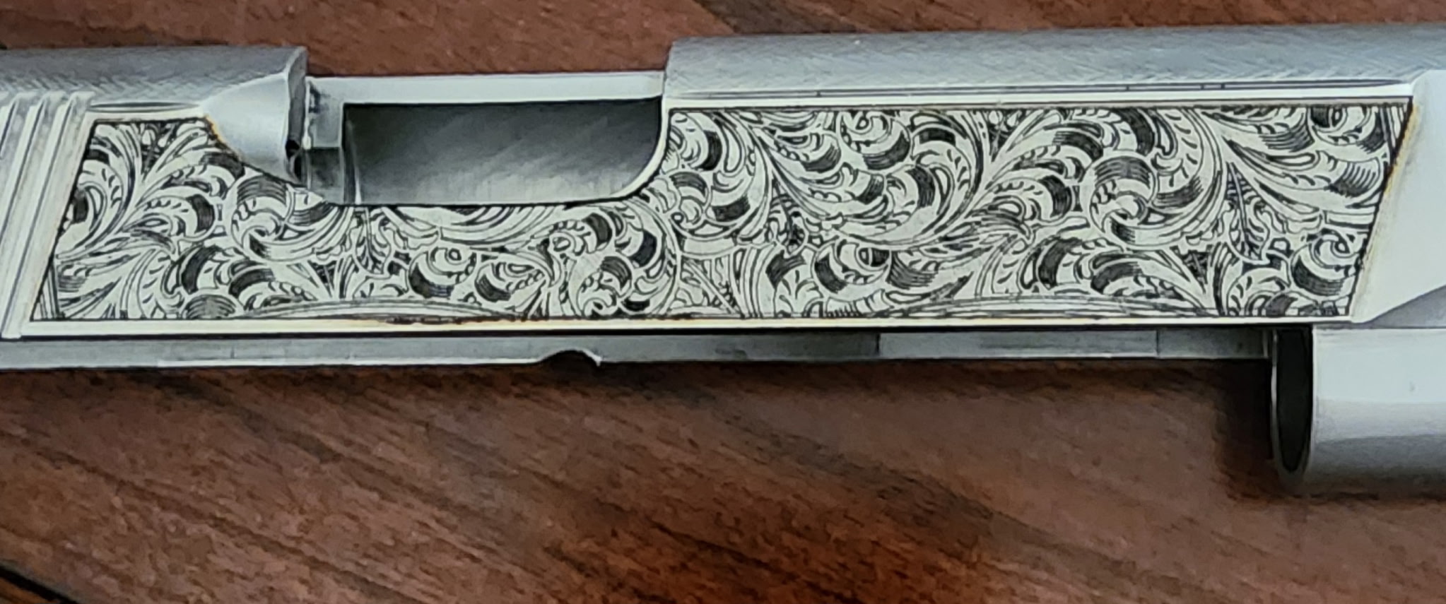 Detailed scroll pattern engraving on rifle